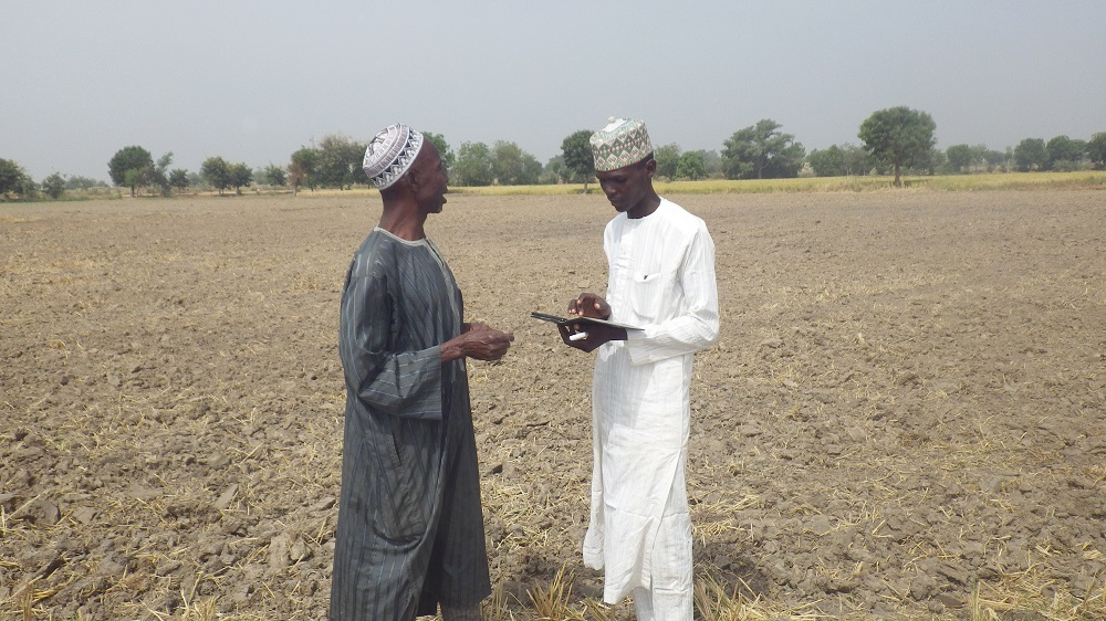 IN NIGERIA, a RiceAdvice service provider (right) collects information to generate customized recommendations on fertilizer options. (Photo by Kokou Ahouanton, AfricaRice.)