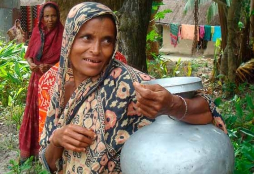 A Farmer's wife carrying a tin-can storage for clean seeds. (Photo: Thelma Paris)