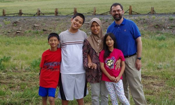 A family portrait of scientists Michael and Septi, taking time off from their rice laboratories with their children Ilham, Irfam, and Atiya. (Photo: Jon Schroeder)