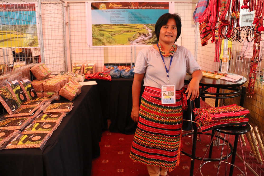 Lily Rosite, a farmer from Kalinga, proudly displays her heirloom rice, for would-be buyers. (Photo: HRP)